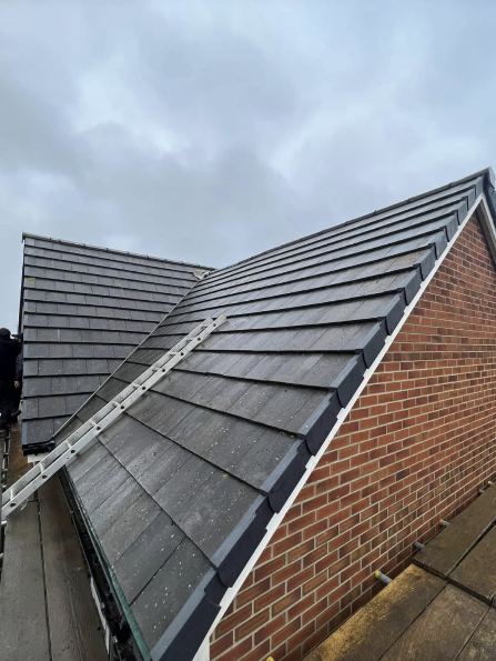 Grey tiled hip roof with new flashing