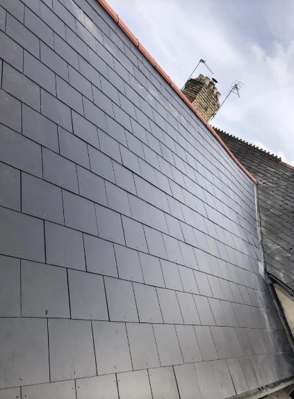 Slate cladding with red ridge tiles