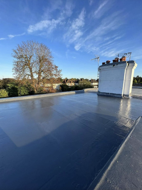 New flat rubber roof with chimney